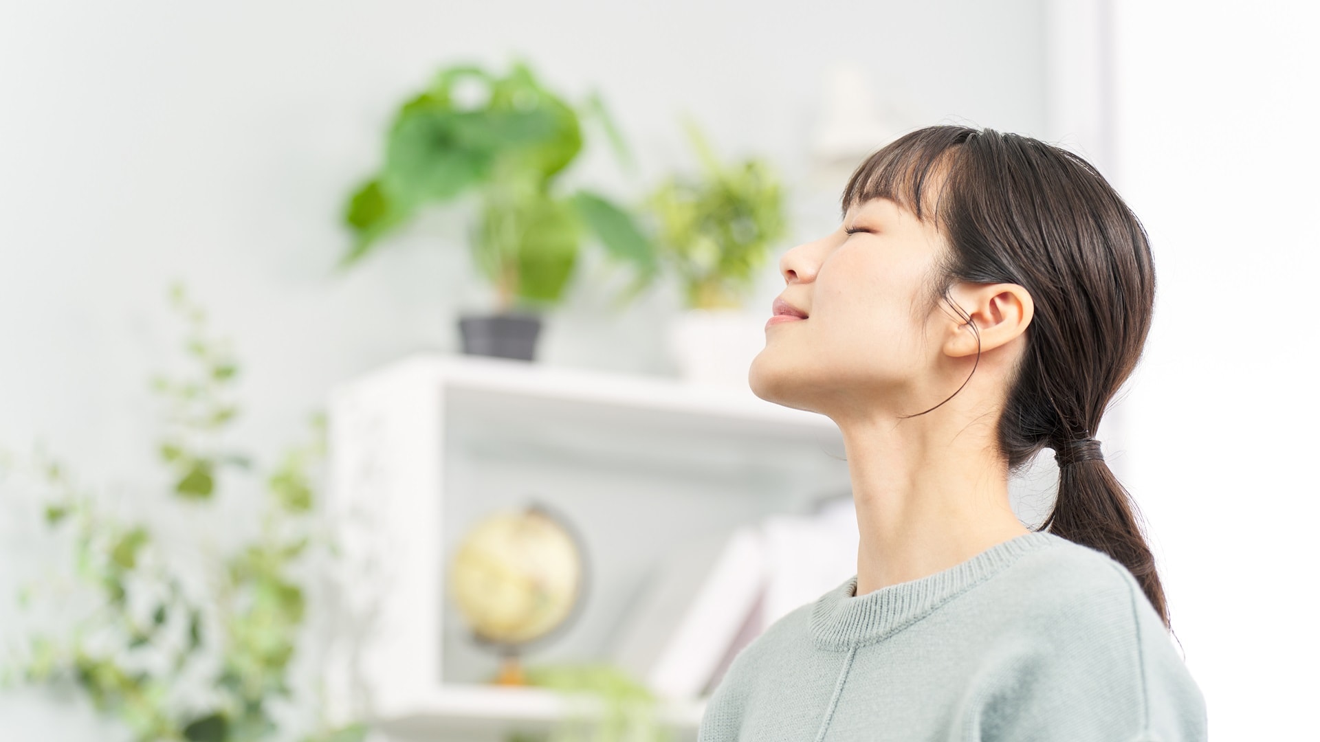 woman-closing-her-eyes-in-the-living-room-2025-03-15-22-07-56-utc